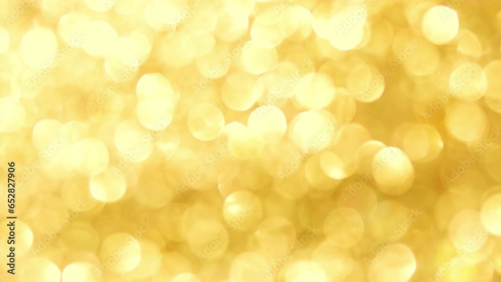 Festive glitter blurred shining gold
background with bokeh and highlights. Festive glitter blurred shining gold
background with bokeh and highlights.