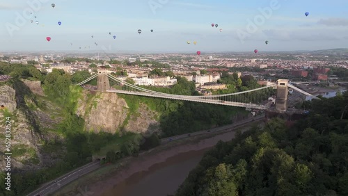 Hot air balloons flying over the Clifton Suspension Bridge and city,  Bristol, England