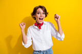 Portrait of glad delighted lady raise fists shout yes hooray accomplishment isolated on yellow color background