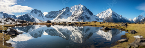 pristine alpine lake, mirror - like water reflecting snow - capped mountains