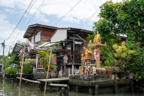A klong or river channel of Chao Phraya river with residential buildings in Bangkok Thailand Asia