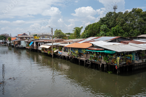 A klong or river channel of Chao Phraya river with residential buildings in Bangkok Thailand Asia