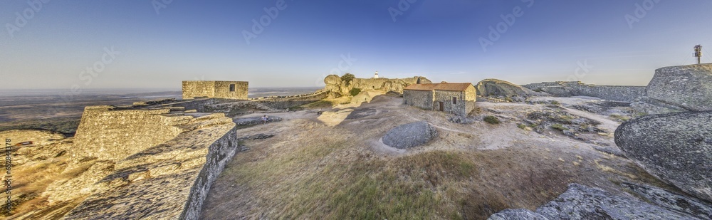 Panoramic image of the fortification above the historic town of Monsanto in Portugal during sunrise