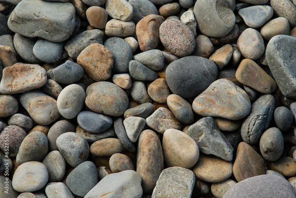 Rounded stones on a beach in Maine's Arcadia National Park with tones of gray, gold, rust, white. Rounded stones on a beach in Maine's Arcadia National Park with tones of gray, gold, rust, white.