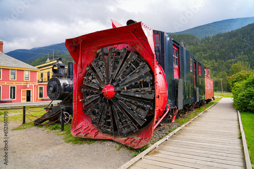 Retired rotary snow plow at the front of an old White Pass & Yukon Railroad train in the city center of Skagway, Alaska - Old snow blower train in the Klondike Gold Rush National Historic Park