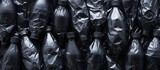 Black garbage bags holding plastic bottles waiting for recycling