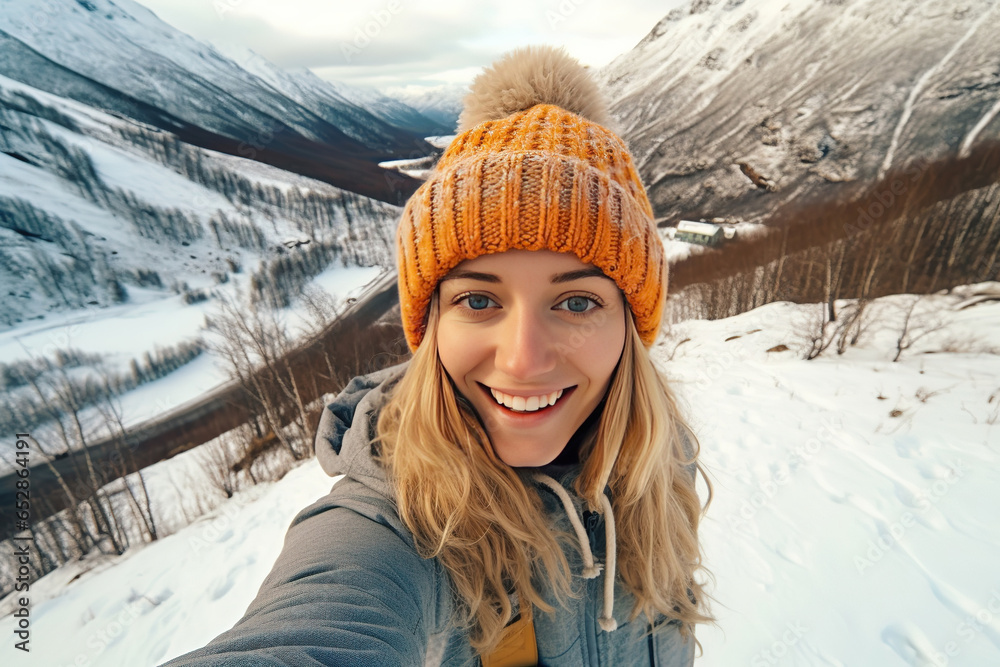 Portrait of a young sporty woman in a knitted hat, taking a selfie and having fun on a winter day in the mountains. healthy lifestyle. Portrait of a young sporty woman in a knitted hat, taking a selfie and having fun on a winter day in the mountains. healthy lifestyle.
