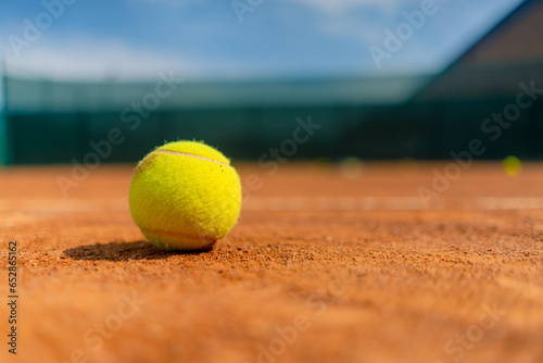 close-up sports equipment a small ball lies on an open ground orange court hobby competition sport © Guys Who Shoot