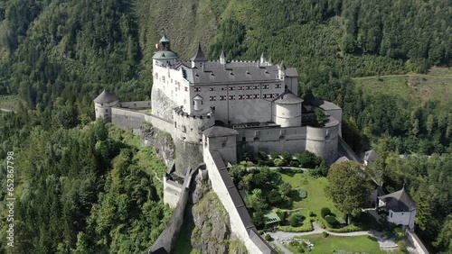 Hohenwerfen Fortress in the Pongau region of Salzburg. On the steep peak, high above the Salzach valley Austrian Alps, Austria, Europe. Medieval rock fortress. Aerial. Summer.