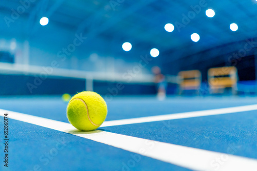 a small bright ball lies on the tennis court professional sport training hobby game © Guys Who Shoot