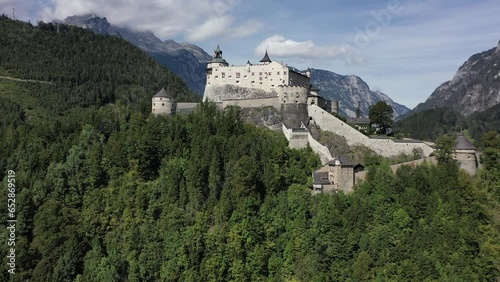 Hohenwerfen Fortress in the Pongau region of Salzburg. On the steep peak, high above the Salzach valley Austrian Alps, Austria, Europe. Medieval rock fortress. Aerial. Summer. photo