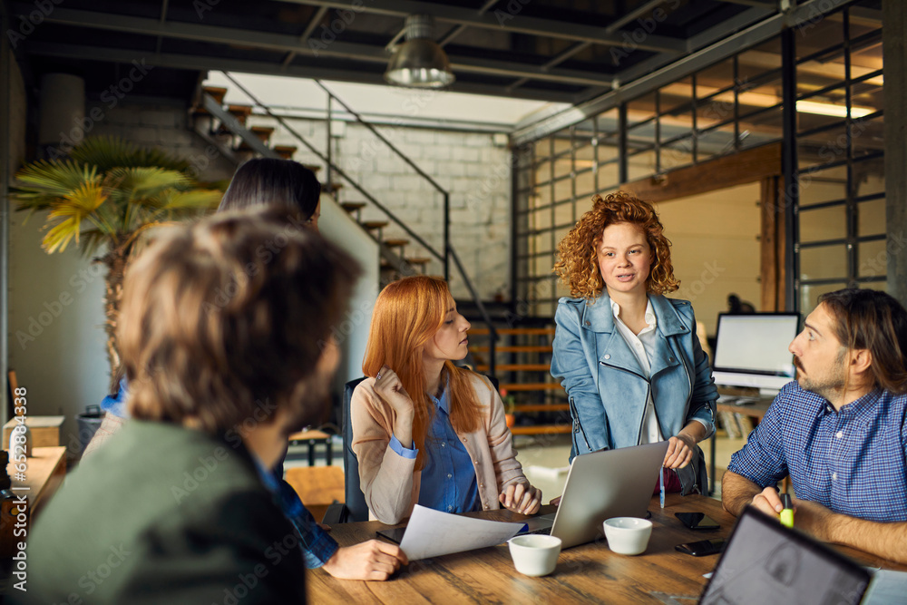 Young and diverse group of designers having a meeting in an office while working in a startup company Young and diverse group of designers having a meeting in an office while working in a startup company