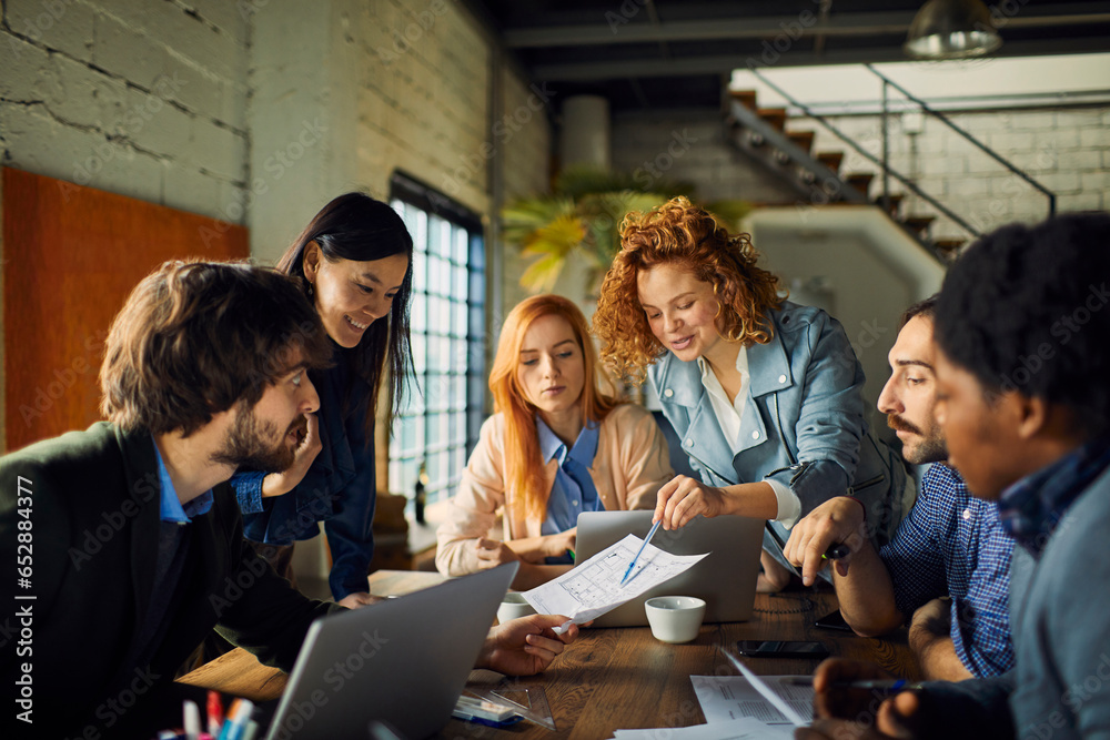 Young and diverse group of designers having a meeting in an office while working in a startup company Young and diverse group of designers having a meeting in an office while working in a startup company