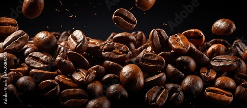 Coffee beans falling on white background for coffee product advertising with selective focus