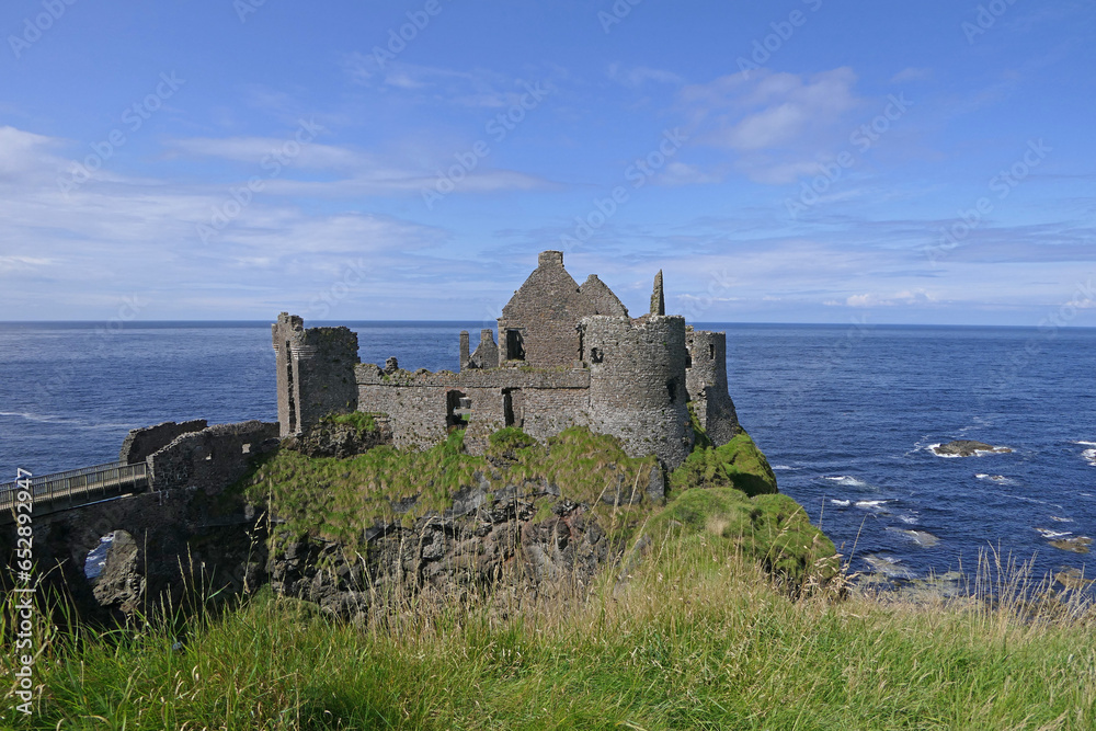 Dunluce Castle on Irish Sea and Atlantic Ocean Co Antrim Northern Ireland with blue sea background