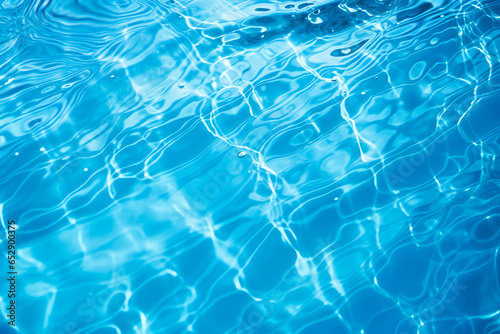 Blue water surface with ripples and bubbles reflections of light