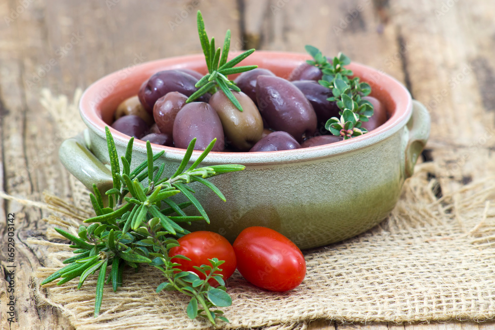 red kalamata olives, tomatoes and herbs in a bowl red kalamata olives, tomatoes and herbs in a bowl