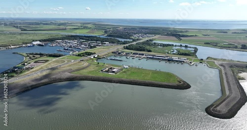 aerial drone view of a sea port in the province of Zeeland, The Netherlands. Also leading into a the sixth structure of the Delta Works . Port for businness liek fishery, leisure sailing, and photo