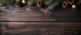 Dark wooden board with fir tree and decoration in Christmas background