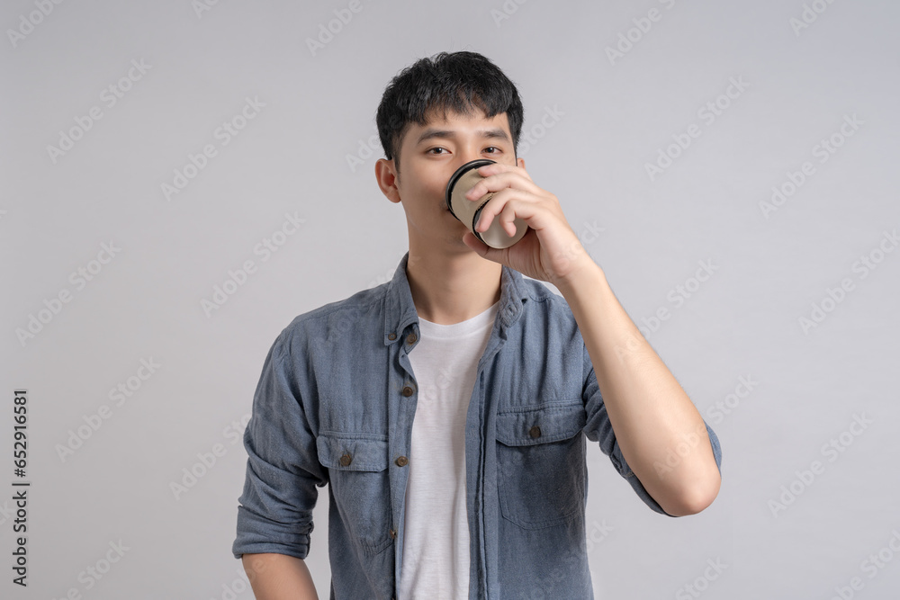 Man holding paper cup with hot coffee and smiling happily. Man holding paper cup with hot coffee and smiling happily.