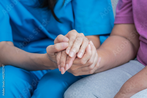Fototapeta Naklejka Na Ścianę i Meble -  Close up images, The doctor holding hands patient  to give advice and encourage To fight the disease And cheer to receive treatment, to elderly patient and health care concept.