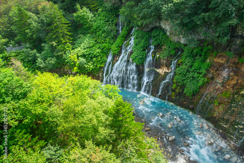 Shirahige Waterfall, mean White Beard, with deep cobalt blue hue Biei river flow beneath, Biei, Kamikawa Subprefecture, Hokkaido, Japan