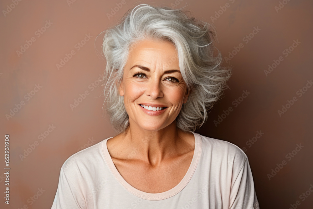 Smiling elderly woman with gray hair on a beige background Smiling elderly woman with gray hair on a beige background