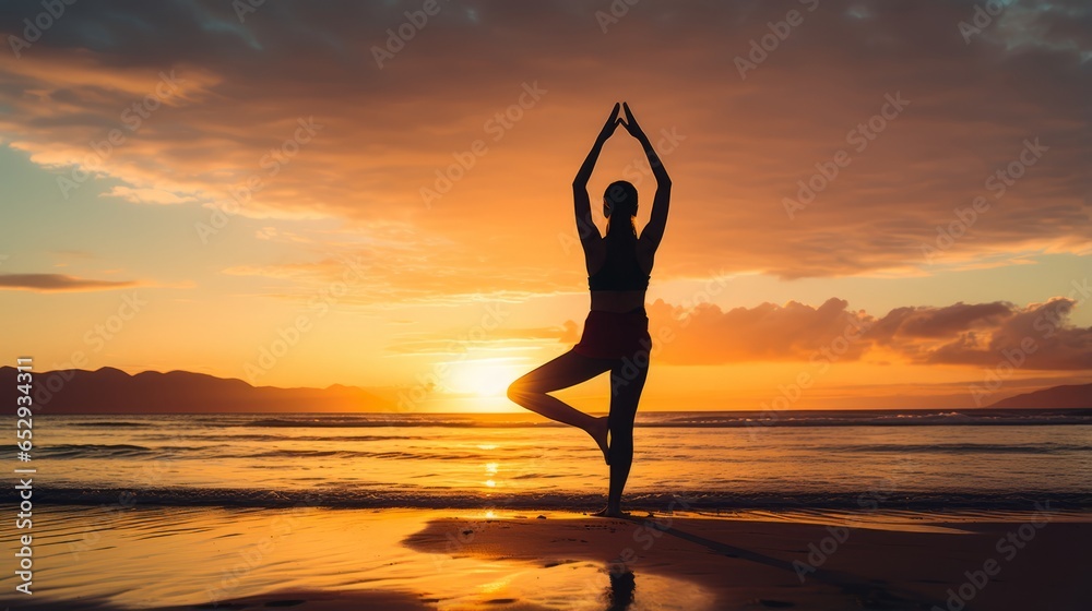 A woman doing yoga on a peaceful beach at sunset