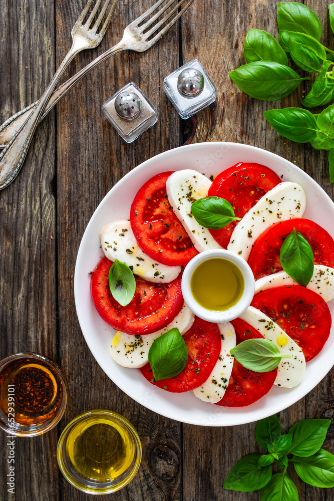 Caprese salad on wooden table
