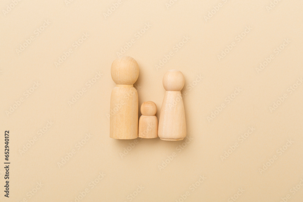 Wooden family figures on color background, top view. Wooden family figures on color background, top view.