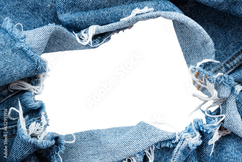 Fototapete Hole in denim on a white background. Ripped jeans