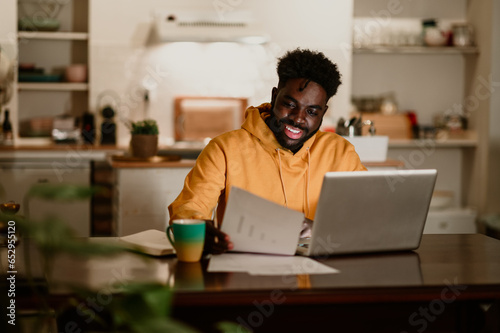 African american entrepreneur is sitting at home and working