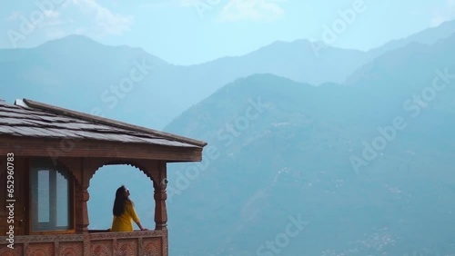 Indian tourist girl standing at Naggar castle with the mountains in background at Manali, Himachal Pradesh, India. Tourism and Holiday concept. photo