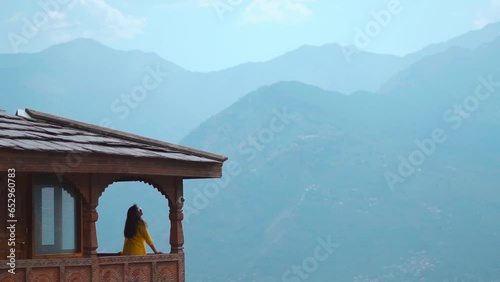 Indian tourist girl standing at Naggar castle with the mountains in background at Manali, Himachal Pradesh, India. Tourism and Holiday concept.