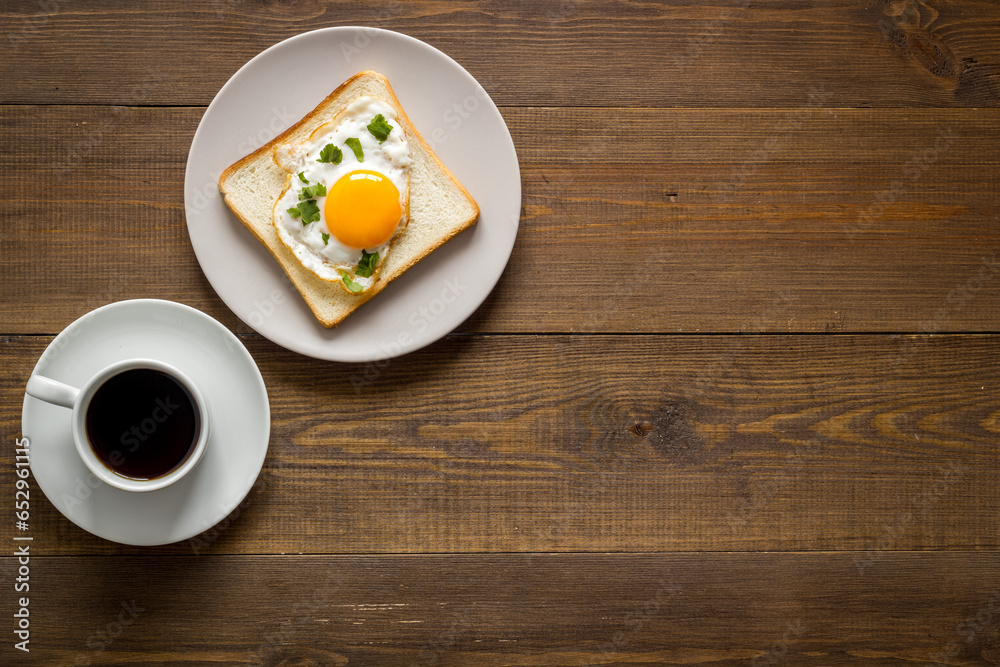 Breakfast with fried eggs on toast bread and cup of black coffee Breakfast with fried eggs on toast bread and cup of black coffee