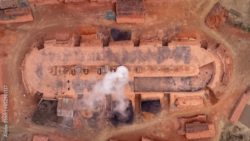 Top-Down View of a Brick Kiln with Smoke Emitting from the Chimney photo