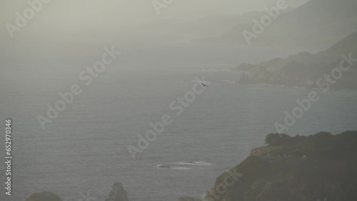 Bird Flying over Misty Coastline of Carmel By The Sea and Big Sur - a Rugged Stretch of California Central Coast known for Winding Roads and Seaside Cliffs