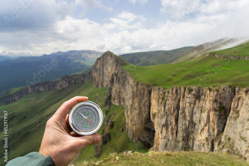 On the ground compass with mountain view