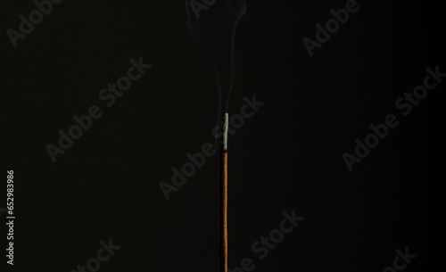 Incense stick burning in the dark