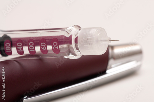 Insulin pen injector. Insulin pen fill with needle on white background. Diabetes Day.