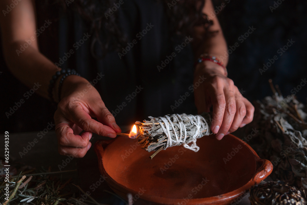 Approach to a hand lighting an incense burner, Halloween, spiritual beliefs, white magic - obrazy, fototapety, plakaty 