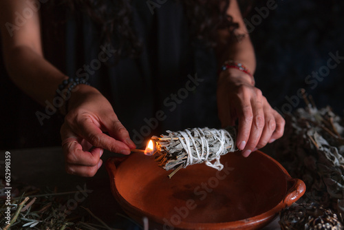Approach to a hand lighting an incense burner, Halloween, spiritual beliefs, white magic