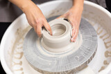 skilled hands of master on potter's wheel create future craft tableware