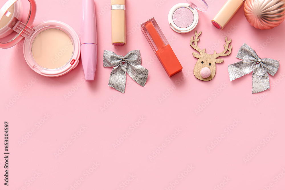 Naklejka premium Composition with decorative cosmetics and Christmas decor on pink background