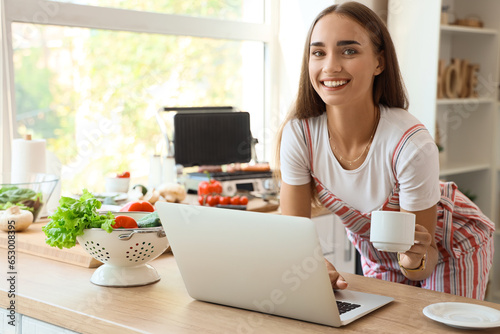 Beautiful young woman using...