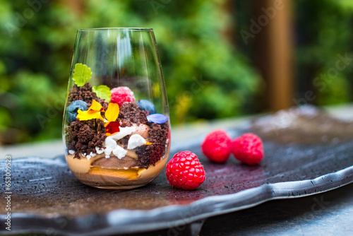 Chocolate mousse cake dessert with berries in glass photo