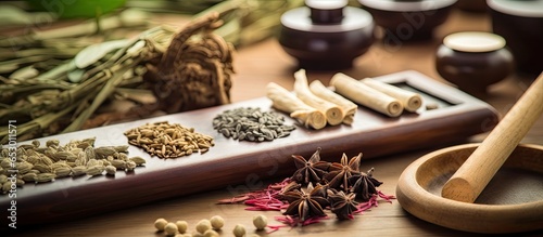 Chinese traditional medicine with herb selection acupuncture needles moxibustion therapy calligraphy script and feng shui coins photo