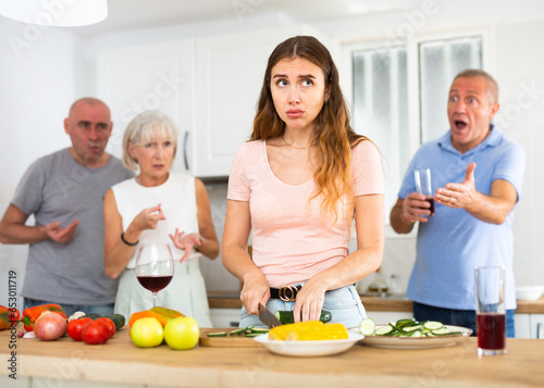 Portrait of a frustrated young woman who had a conflict with her husband and parents while cooking dinner in the kitchen