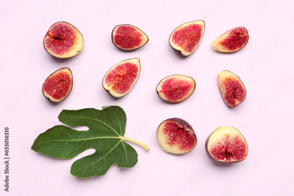 Cut fresh figs and leaf on lilac background Cut fresh figs and leaf on lilac background