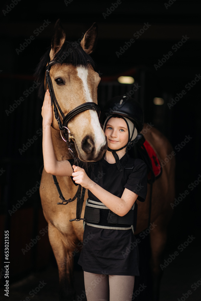 Portrait of a young jockey with a horse, horse riding training, a boy